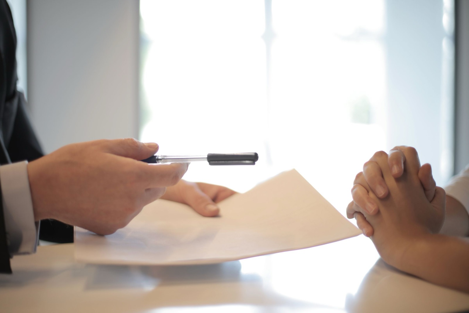 Two people reviewing and signing a contract