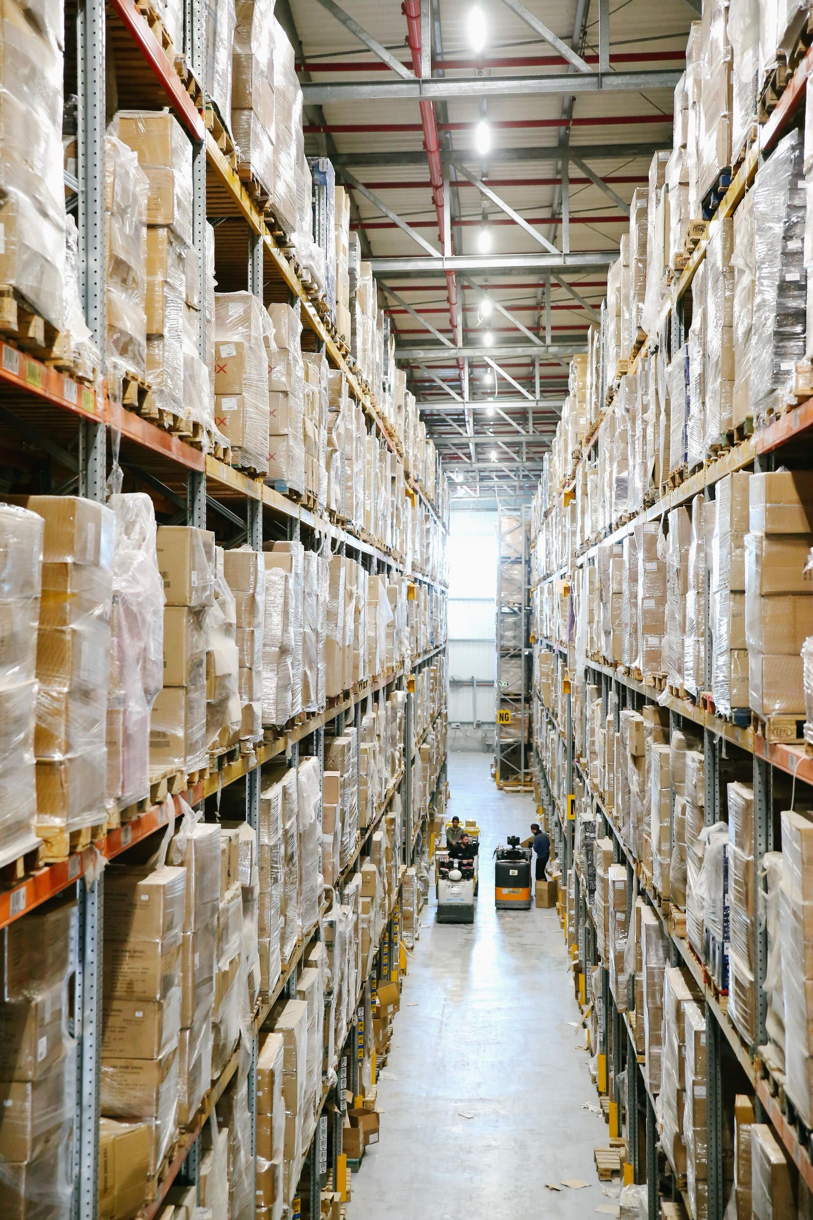 Long aisles of racked inventory in a distribution warehouse